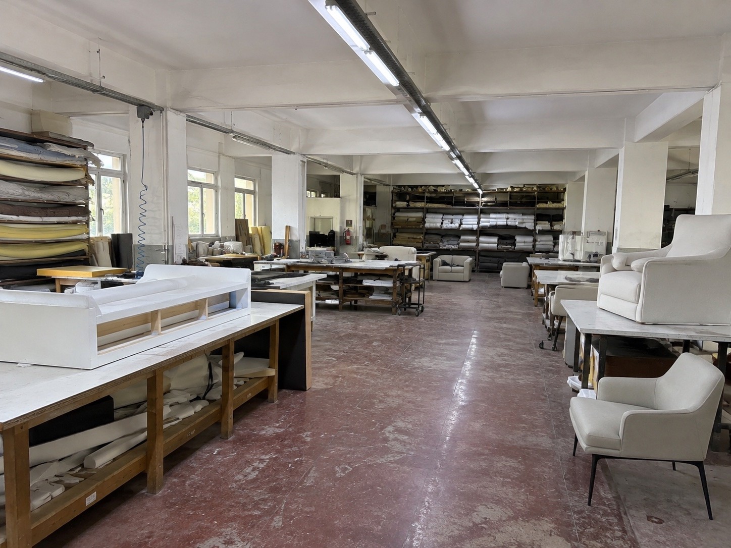 Kavela upholstery hall with foam stock, fabric rolls and frames in progress